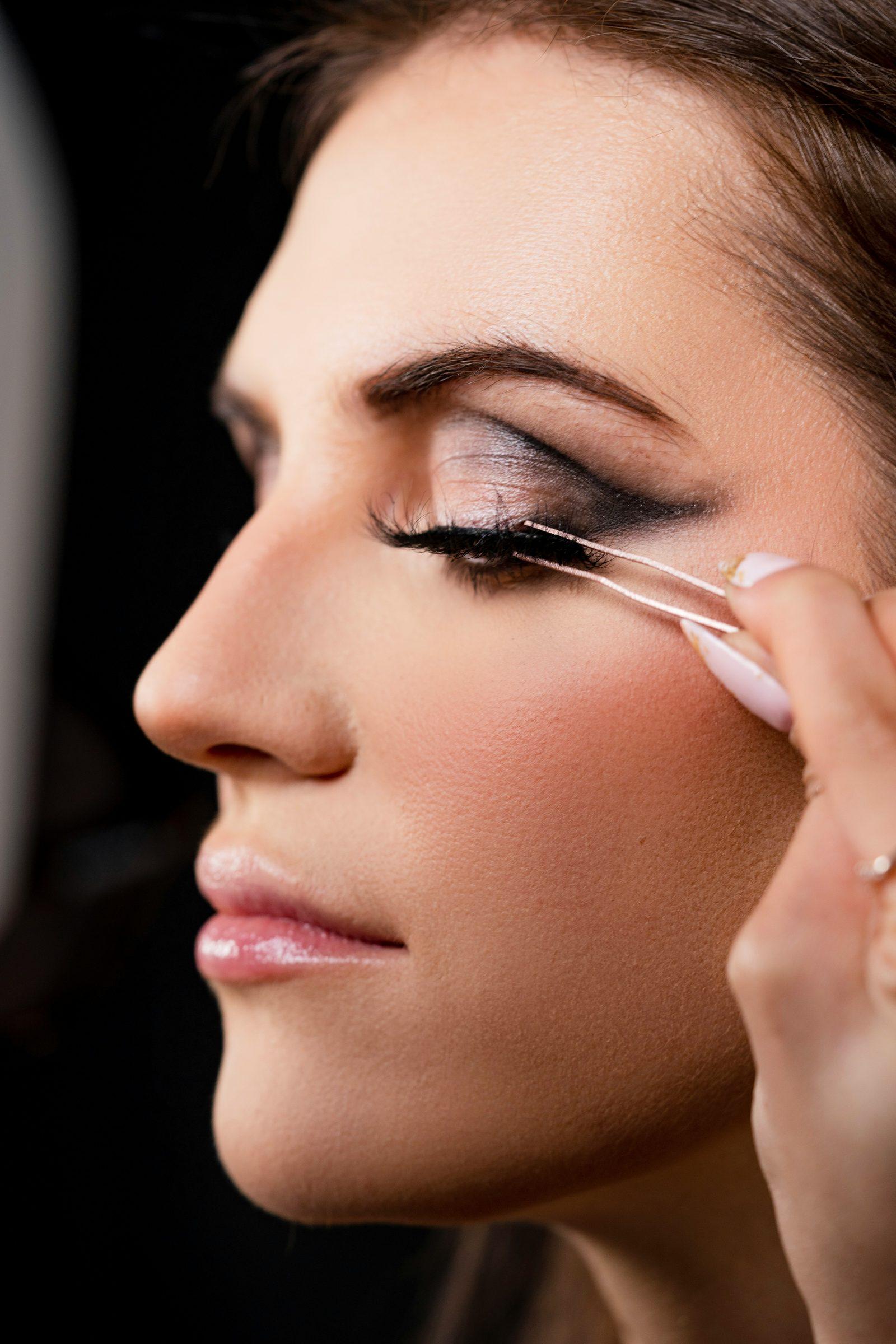 A makeup artist applying bridal eye makeup
